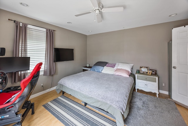 bedroom with ceiling fan, baseboards, wood finished floors, and recessed lighting