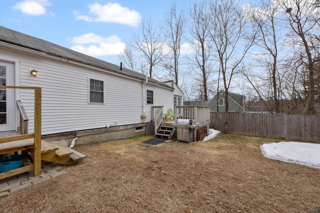 view of yard with a deck and fence