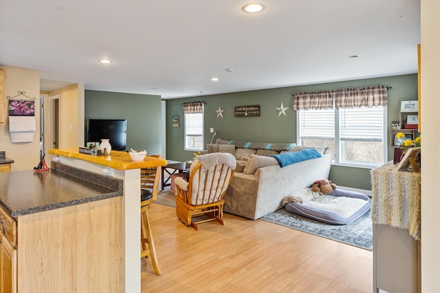 living room with recessed lighting and light wood-style flooring