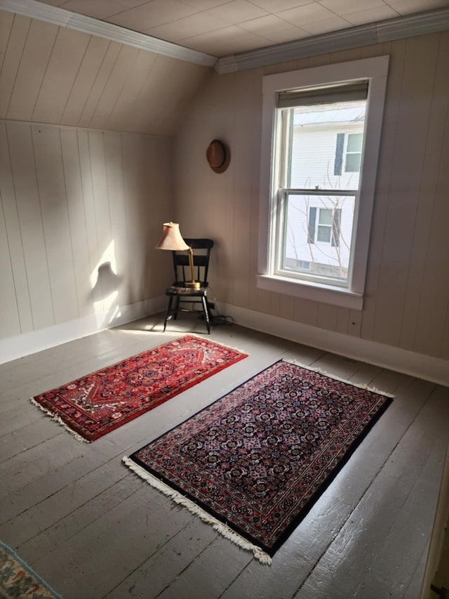 living area with hardwood / wood-style flooring, baseboards, and lofted ceiling