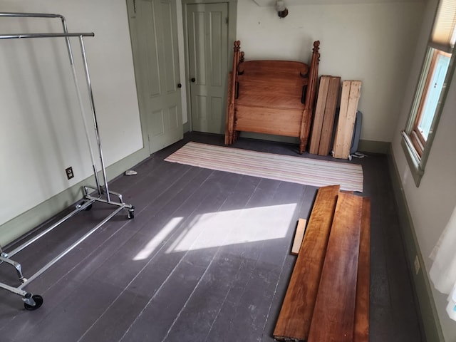 interior space with dark wood finished floors and baseboards