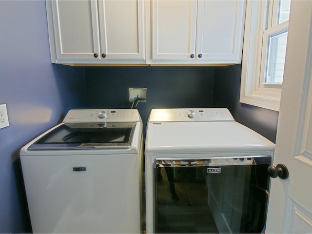 washroom with cabinet space and washing machine and clothes dryer