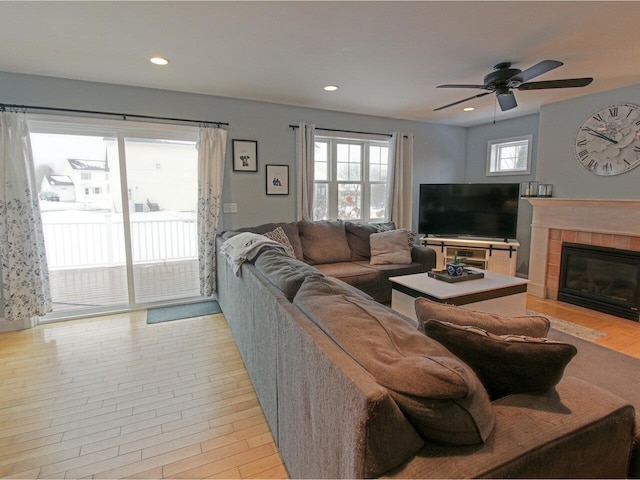 living area featuring a ceiling fan, recessed lighting, a fireplace, and a wealth of natural light