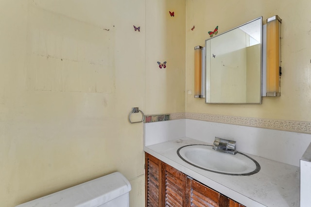 bathroom with toilet and vanity