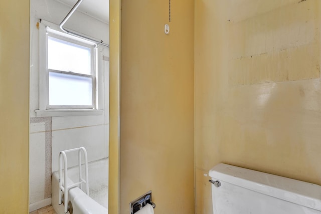 full bath featuring toilet, a shower, and a tub to relax in