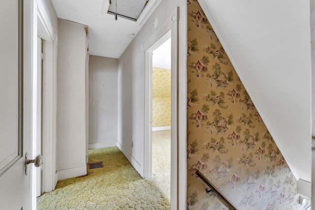 corridor featuring wallpapered walls, baseboards, and visible vents