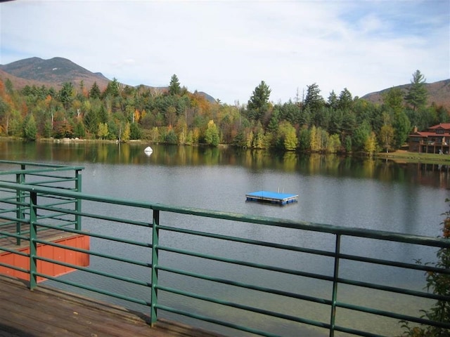 property view of water featuring a mountain view and a forest view