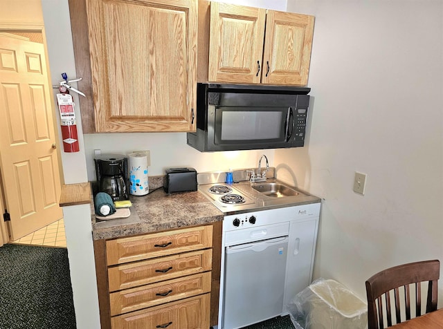 kitchen featuring light brown cabinetry, black microwave, and a sink