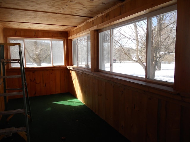 unfurnished sunroom featuring plenty of natural light and wood ceiling