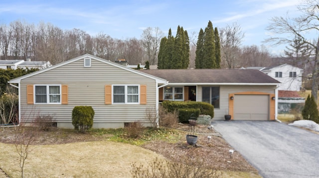 ranch-style home featuring driveway and an attached garage