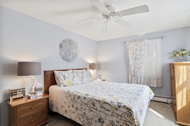 bedroom with a baseboard heating unit, a textured ceiling, dark colored carpet, and ceiling fan