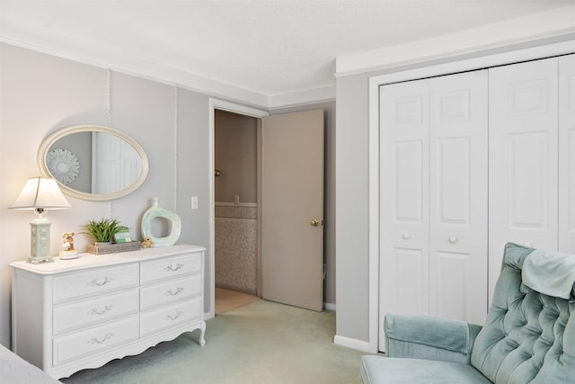 bedroom with a closet and light colored carpet