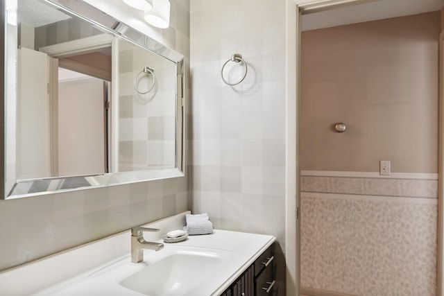 bathroom with tile walls and vanity