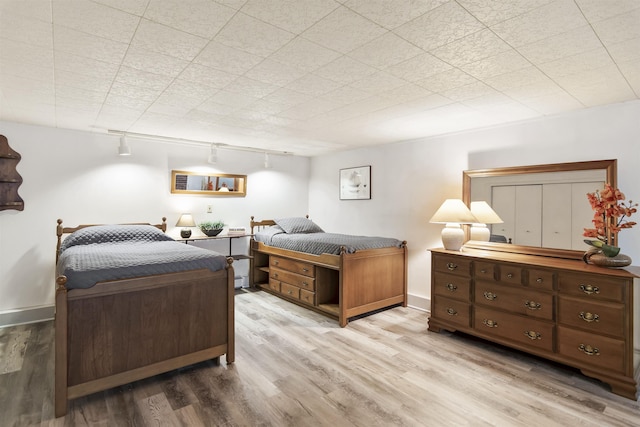 bedroom with wood finished floors and baseboards