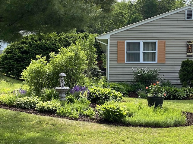 view of side of home featuring a lawn