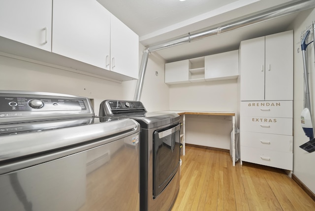 laundry room with cabinet space, separate washer and dryer, and light wood-style flooring