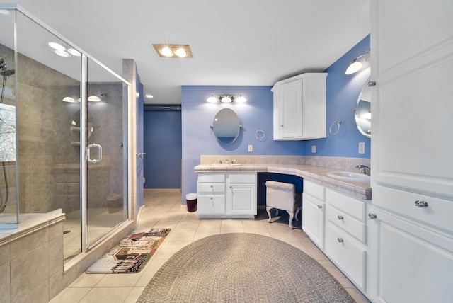 full bath featuring tile patterned flooring, double vanity, a stall shower, and a sink