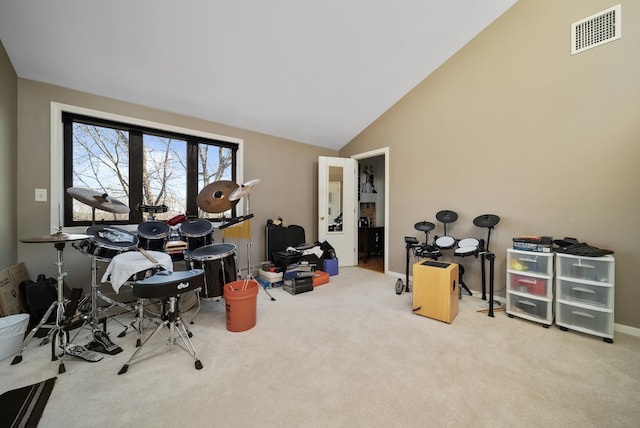 recreation room featuring visible vents, baseboards, carpet, and high vaulted ceiling