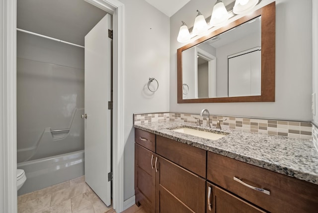 bathroom with tasteful backsplash, shower / washtub combination, vanity, and toilet