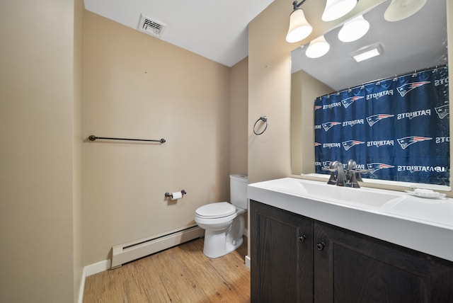 bathroom with vanity, wood finished floors, visible vents, a baseboard radiator, and toilet