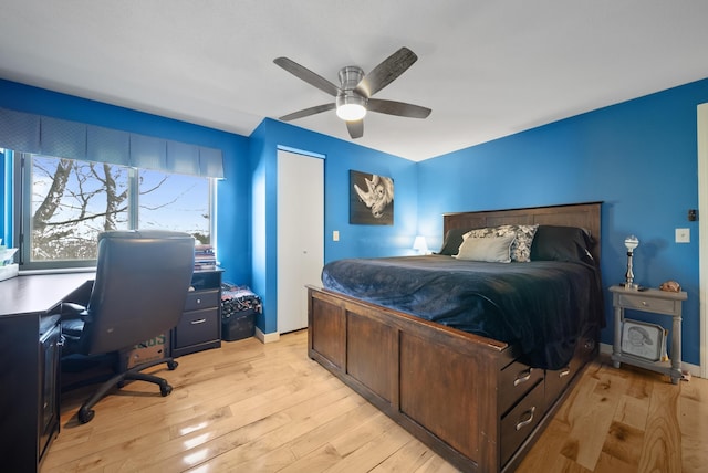 bedroom featuring baseboards, ceiling fan, and light wood finished floors