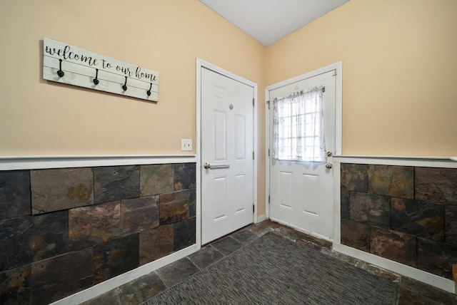 doorway to outside with stone tile flooring