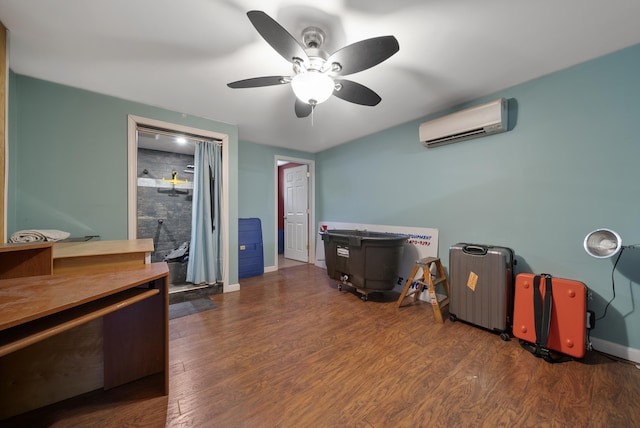 interior space featuring a wall mounted AC, baseboards, and wood finished floors