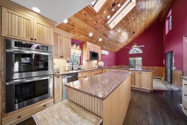 kitchen featuring a kitchen island, stainless steel appliances, a peninsula, wooden ceiling, and wainscoting