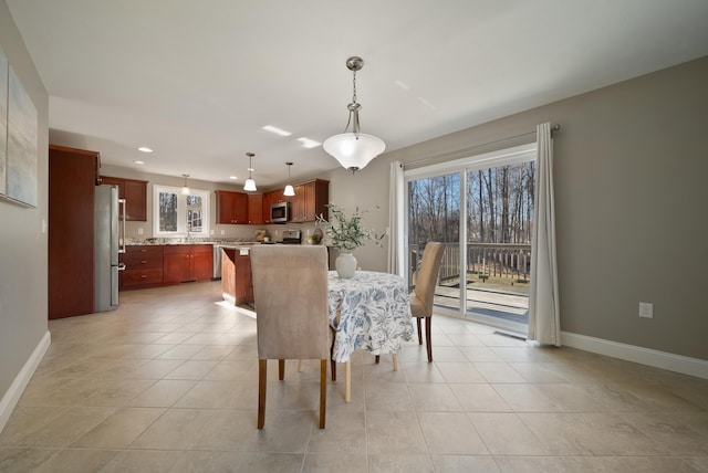 dining room featuring light tile patterned floors, recessed lighting, and baseboards