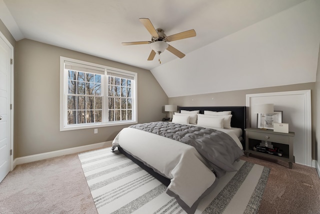 carpeted bedroom with lofted ceiling, baseboards, and ceiling fan