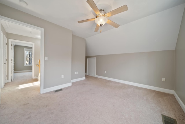 bonus room featuring visible vents, baseboards, attic access, vaulted ceiling, and light carpet