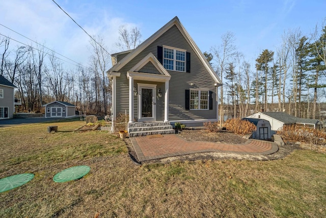 view of front facade featuring an outbuilding, a storage unit, and a front lawn