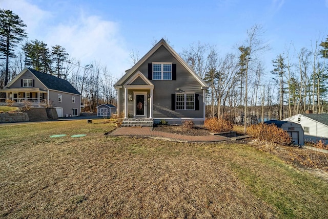 back of house featuring an outbuilding and a lawn