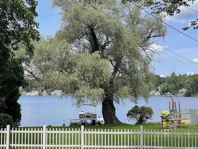 water view featuring fence and a boat dock