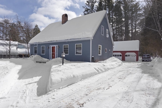 view of front of property featuring an outdoor structure, a garage, and a chimney