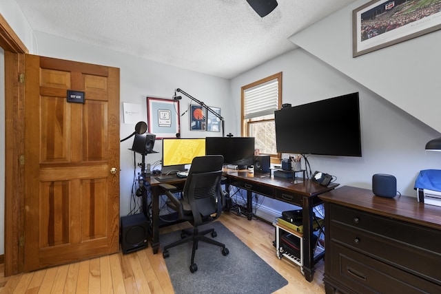 office featuring light wood-style floors and a textured ceiling