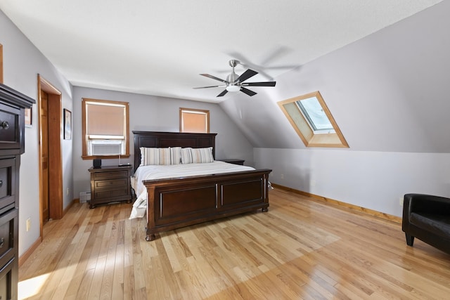 bedroom featuring lofted ceiling, a ceiling fan, baseboards, and light wood finished floors