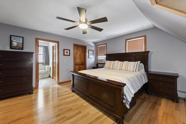 bedroom with connected bathroom, baseboards, ceiling fan, light wood-type flooring, and lofted ceiling