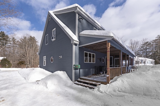 view of snow covered exterior with covered porch