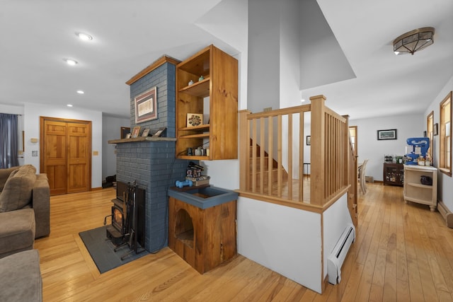 staircase featuring hardwood / wood-style floors, recessed lighting, baseboards, and baseboard heating