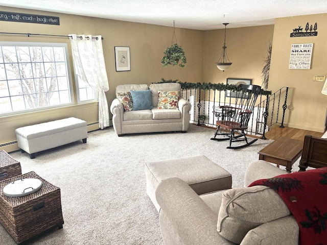 carpeted living room featuring a baseboard radiator, baseboards, and a textured ceiling