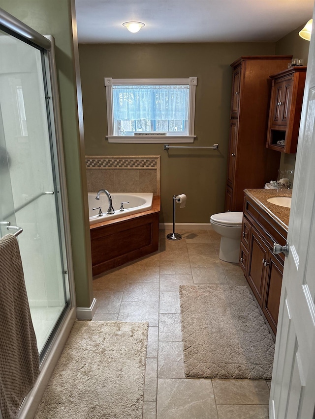 full bath with vanity, baseboards, a shower stall, a garden tub, and toilet