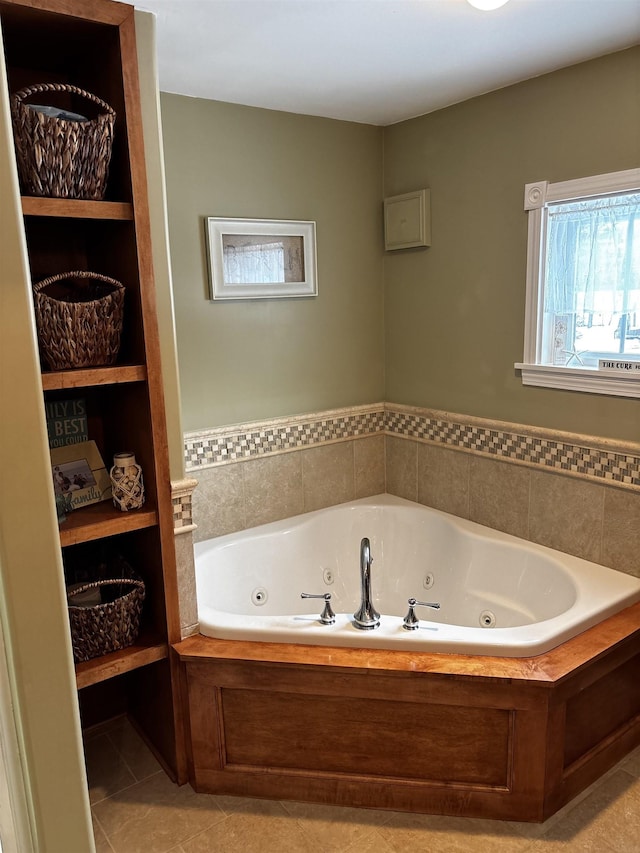 bathroom featuring tile patterned flooring and a whirlpool tub