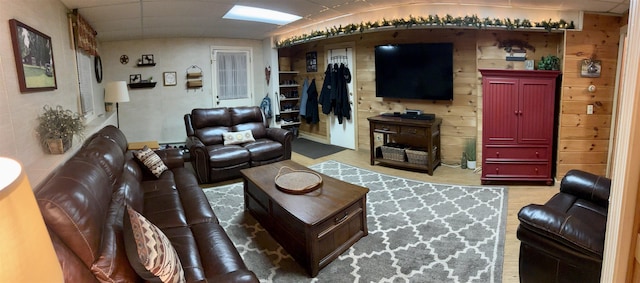 living room featuring wood finished floors and a paneled ceiling