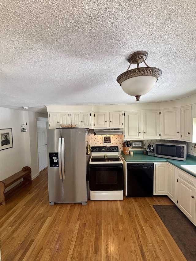 kitchen featuring stainless steel appliances, backsplash, light wood-style flooring, and white cabinetry