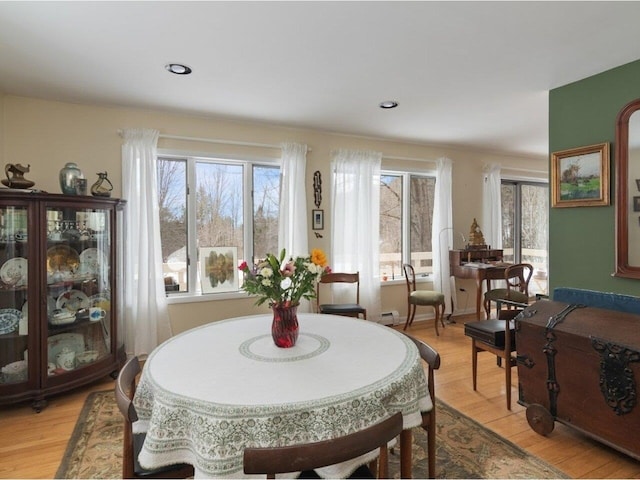 dining space featuring light wood-style flooring, plenty of natural light, and recessed lighting