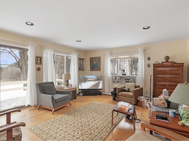 living room with recessed lighting, a healthy amount of sunlight, and light wood finished floors