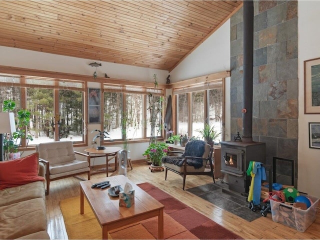 interior space featuring wooden ceiling, a wood stove, and vaulted ceiling