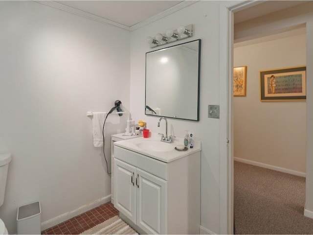 bathroom with vanity, crown molding, toilet, and baseboards