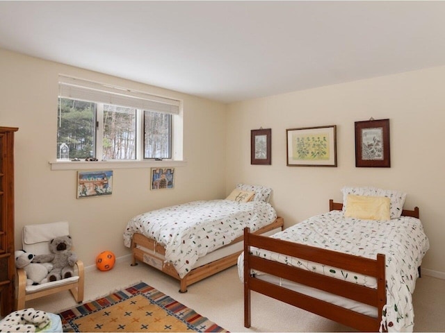 bedroom with baseboards and carpet floors